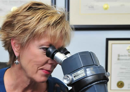 Valuer looking through microscope